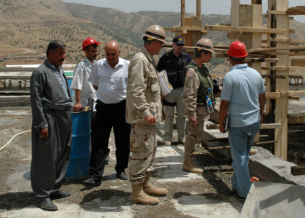 US and Iraqi civilians inspect construction work